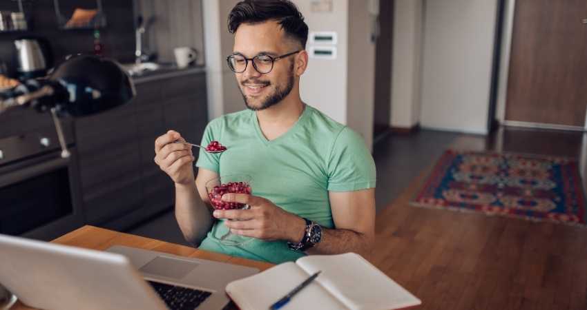 a man eating pomegranate fruit