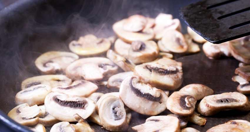 Saute mushrooms in a pan for freezing