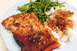 sockeye salmon dinner on a plate with white rice and green beans