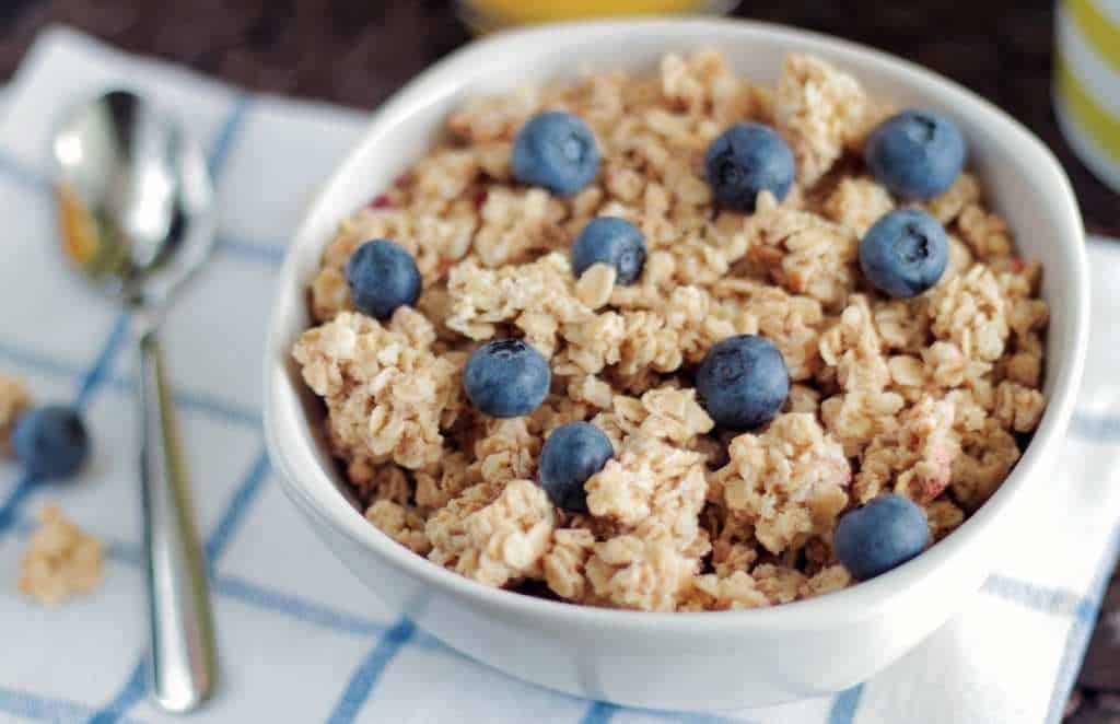 a bowl of breakfast cereal with blueberries