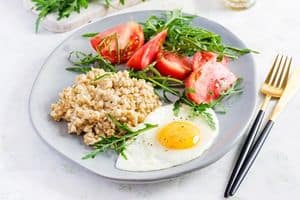 eggs and oatmeal breakfast on a plate