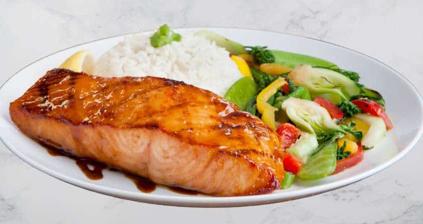 Atlantic salmon dinner with white rice and vegetables.