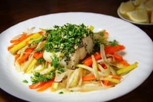 cod dinner on a plate with vegetables