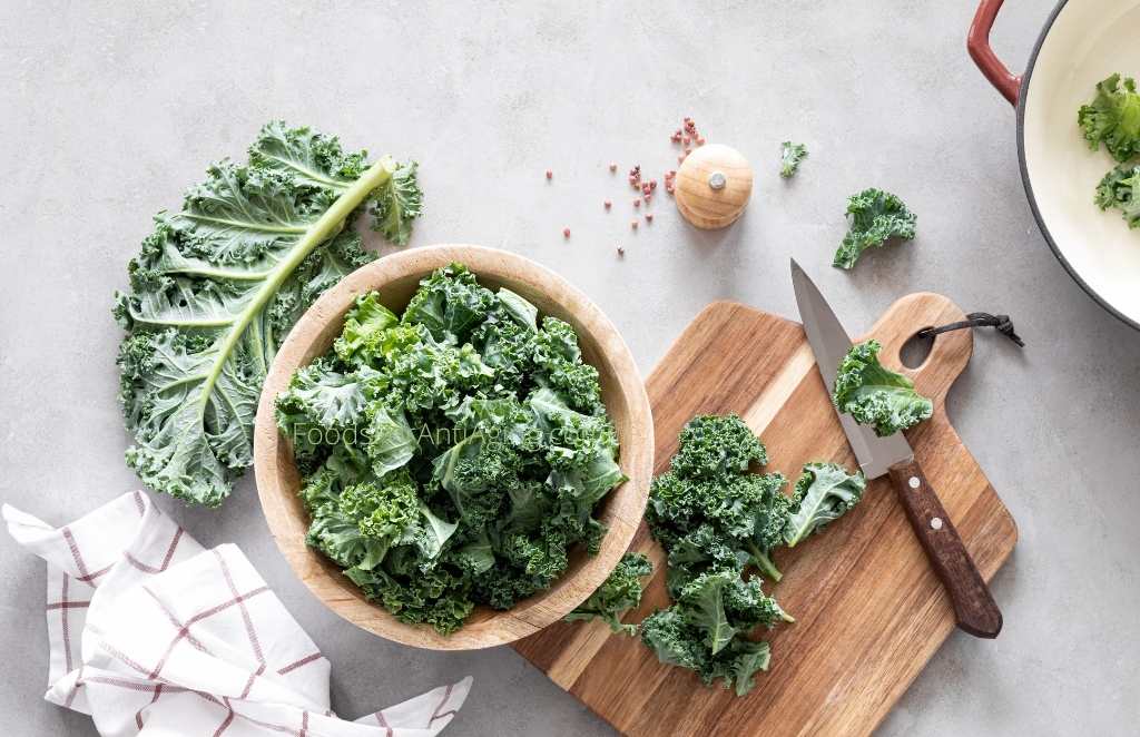 cutting and desteming kale on a cutting board