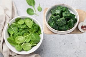 frozen and fresh spinach in bowls