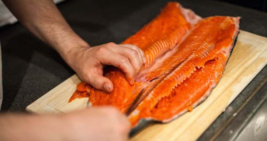 Preparing fillets of sockeye salmon.