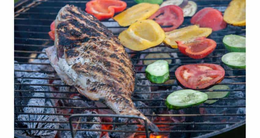 Cooking sunfish on the charcoal grill.