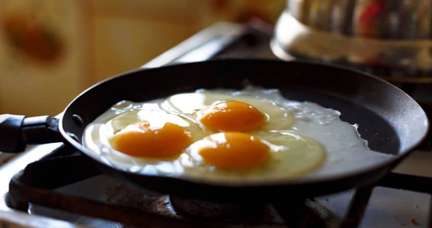 Frying eggs with avocado oil.