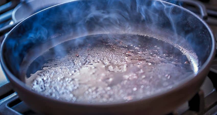Oil smoking in a frying pan.