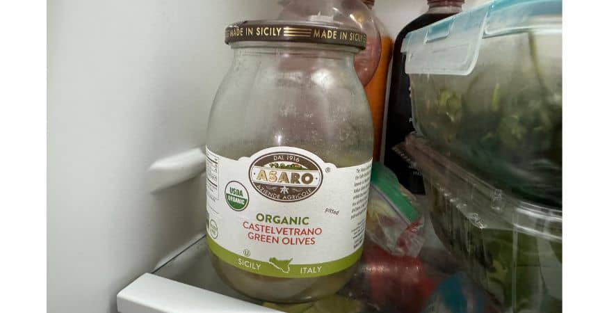 Organic green olives stored in my refrigerator at home.
