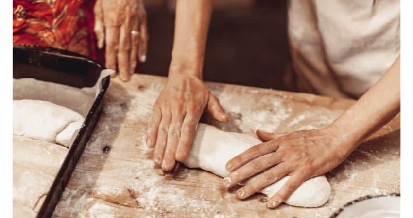 Preparing bread dough on wood.