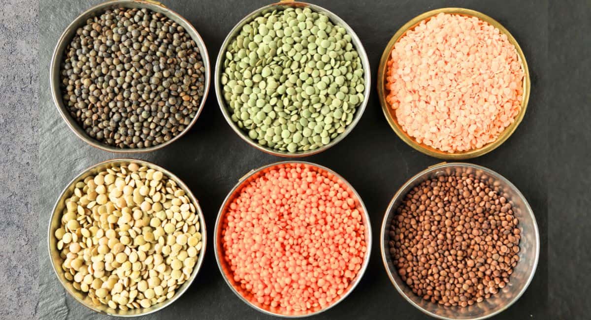 Different color lentils in bowls.