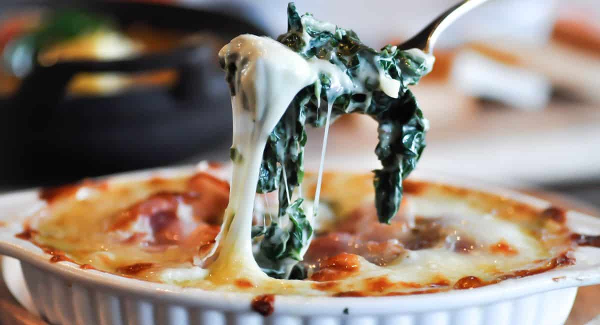 Spinach dip with cheese in a bowl.