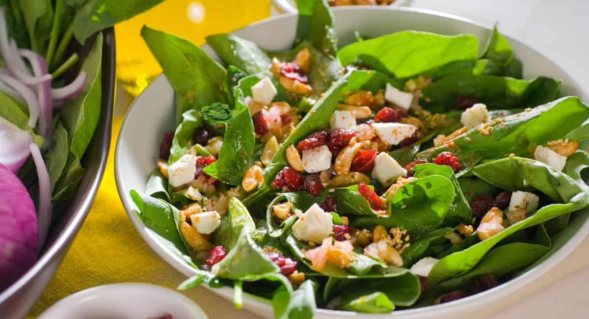 Spinach salad with cheese, nuts and berries.